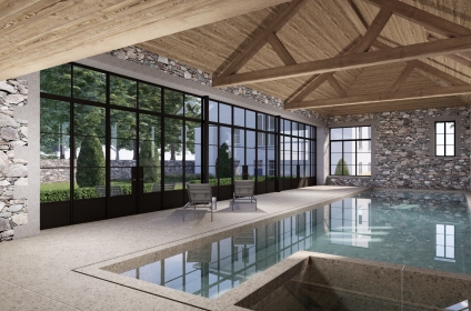 Pool house integrated between existing stone outbuildings and main house in Guernsey.