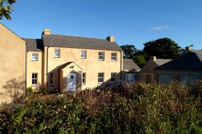 pair_of_cottages_huddled_together_with_salvaged_stone_roof_1