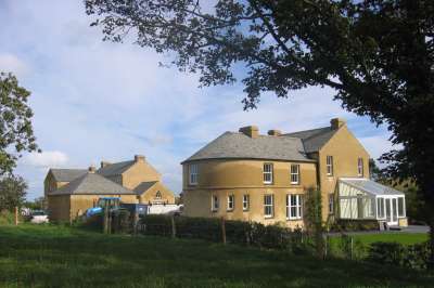 pair_of_cottages_huddled_together_with_salvaged_stone_roof_6